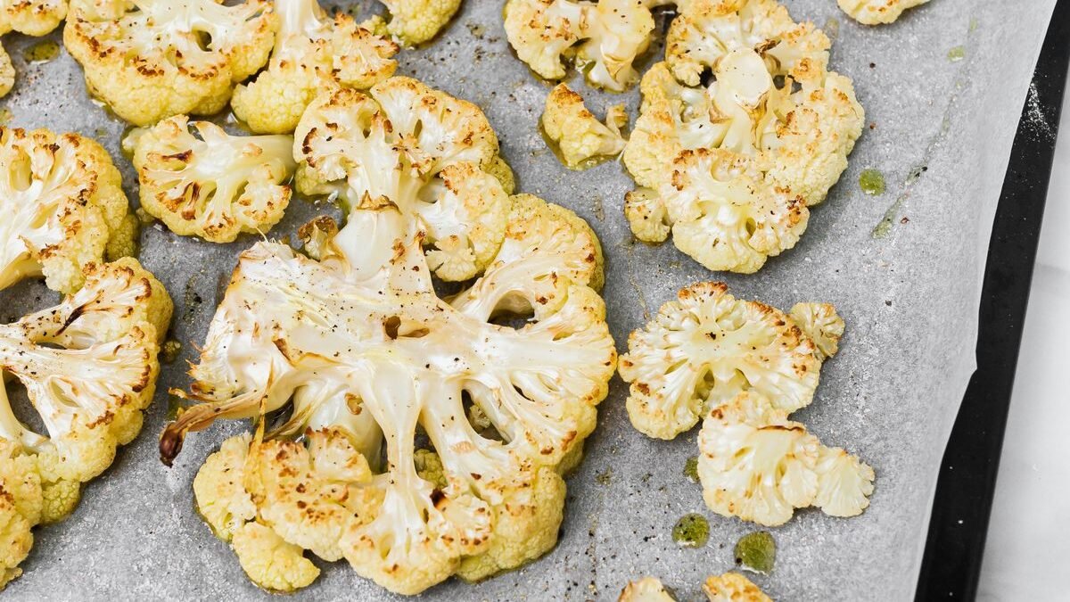 Sheet pan of golden roasted cauliflower florets with garlic