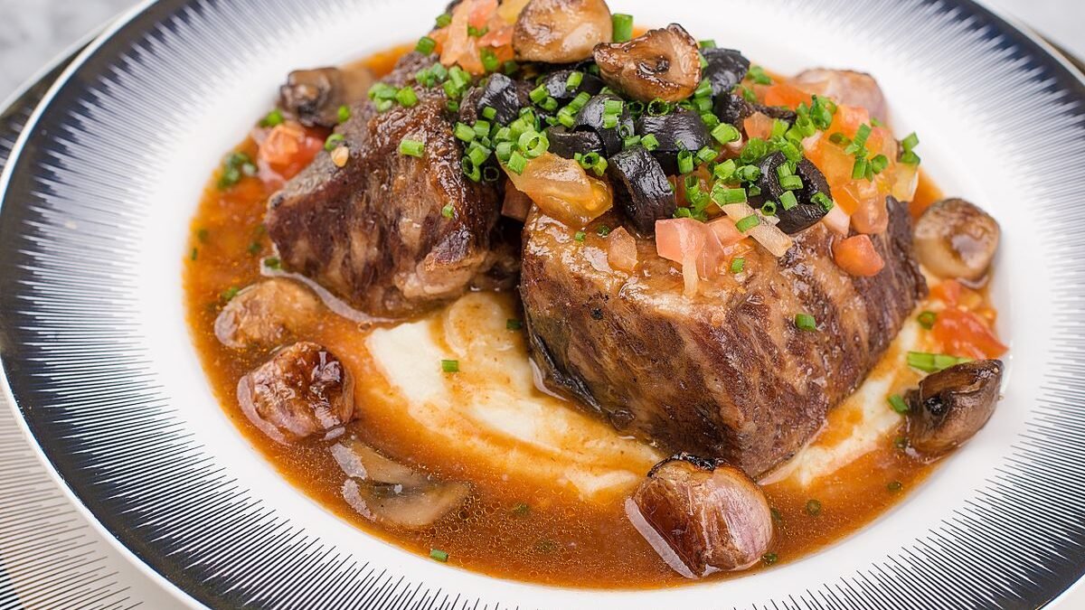 Braised beef short ribs over creamy mash with mushrooms and rich sauce